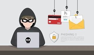 hacker using phishing and smishing attacks